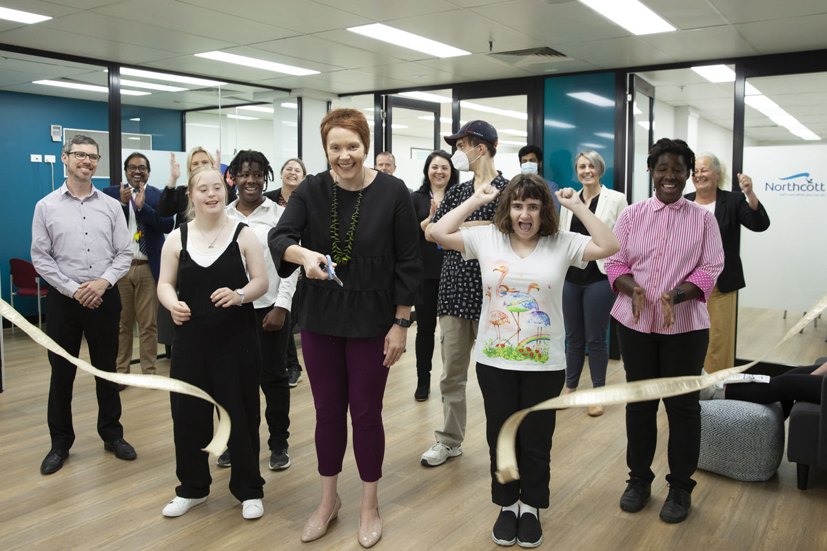 Northcott CEO Liz Forsyth cuts the ribbon to open our new office in Hornsby, surrounded by customers and staff