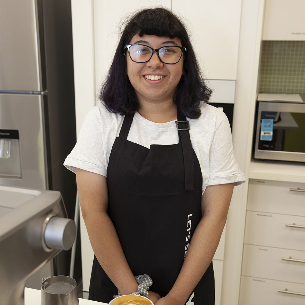 Cafe Thanks a Latte participant with coffee she has made